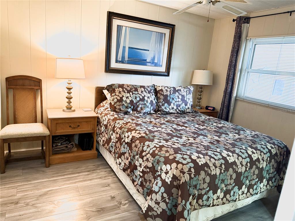 8010 Highpoint Boulevard Brooksville, FL 34613 - Photo 14 of 32 a bed sitting in a bedroom next to a window with bathroom