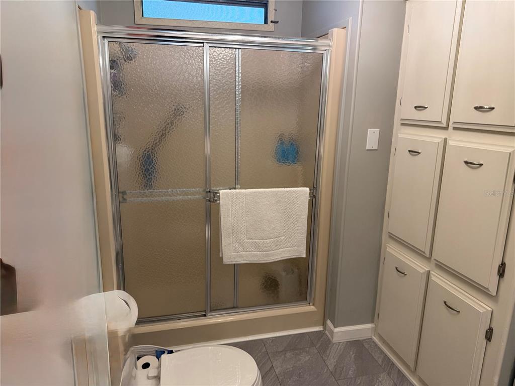 8010 Highpoint Boulevard Brooksville, FL 34613 - Photo 16 of 32 a bathroom with a granite countertop shower and a sink