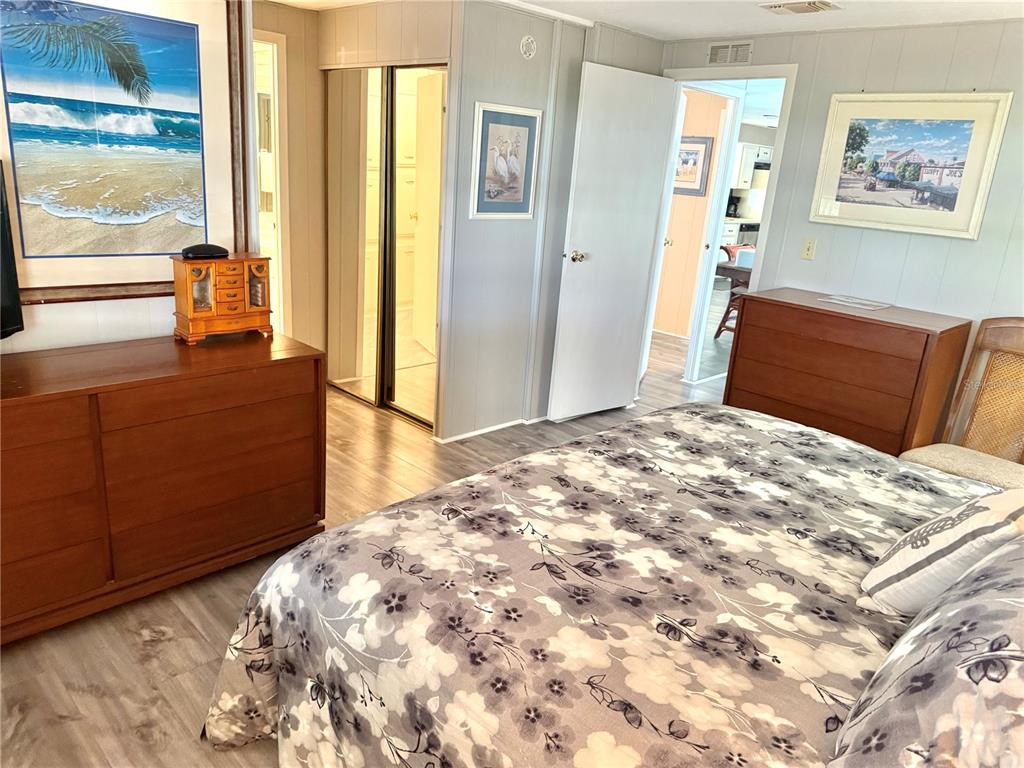 8010 Highpoint Boulevard Brooksville, FL 34613 - Photo 17 of 32 a bedroom with a bed and a dresser next to a window