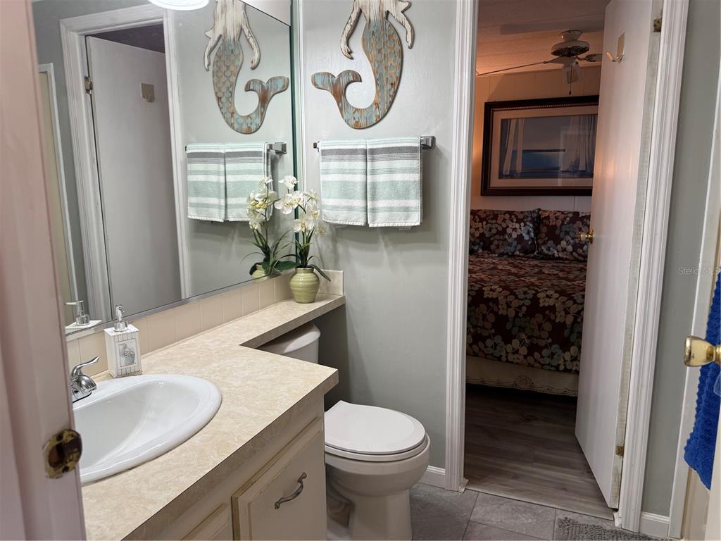 8010 Highpoint Boulevard Brooksville, FL 34613 - Photo 18 of 32 a bathroom with a toilet a sink and mirror