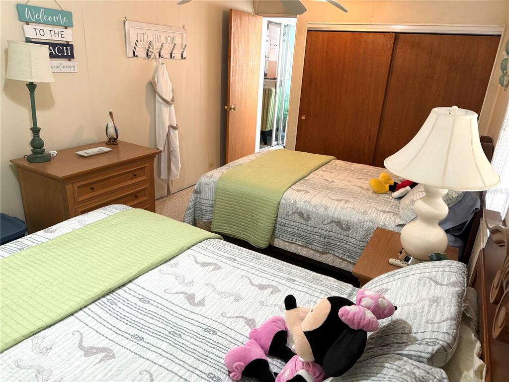 8010 Highpoint Boulevard Brooksville, FL 34613 - Photo 20 of 32 a bedroom with two bed and a lamp