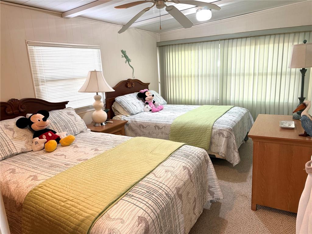 8010 Highpoint Boulevard Brooksville, FL 34613 - Photo 21 of 32 a bedroom with two beds and a window