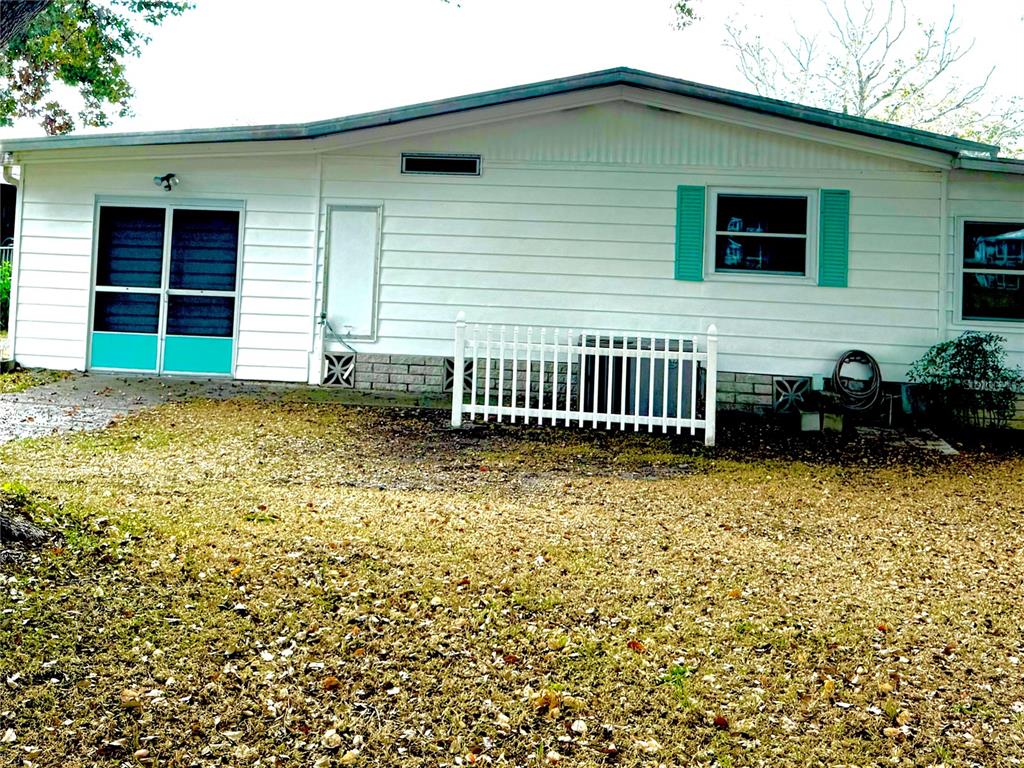 8010 Highpoint Boulevard Brooksville, FL 34613 - Photo 22 of 32 a front view of a house with garden