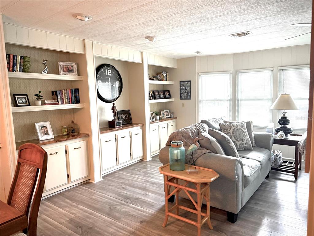 8010 Highpoint Boulevard Brooksville, FL 34613 - Photo 8 of 32 a living room with furniture and a window