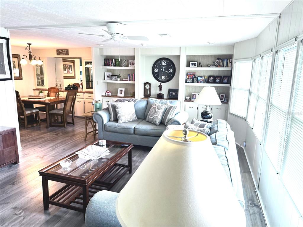 8010 Highpoint Boulevard Brooksville, FL 34613 - Photo 9 of 32 a living room with furniture and wooden floor