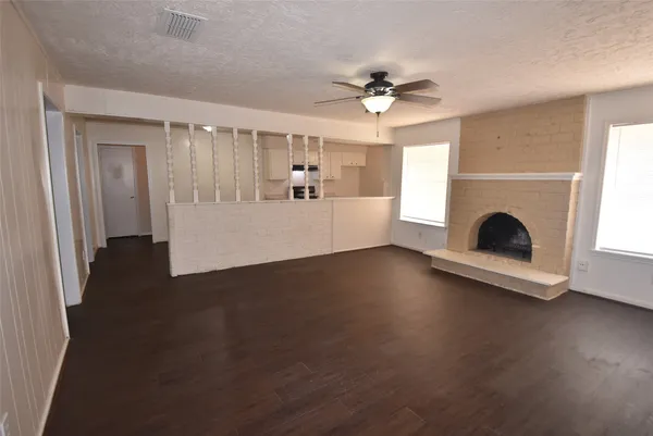 a view of a livingroom with furniture wooden floor and a fireplace