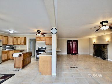 828 North Balsam Street Ridgecrest, CA 93555 - Photo 2 of 32 a large kitchen with cabinets and stainless steel appliances