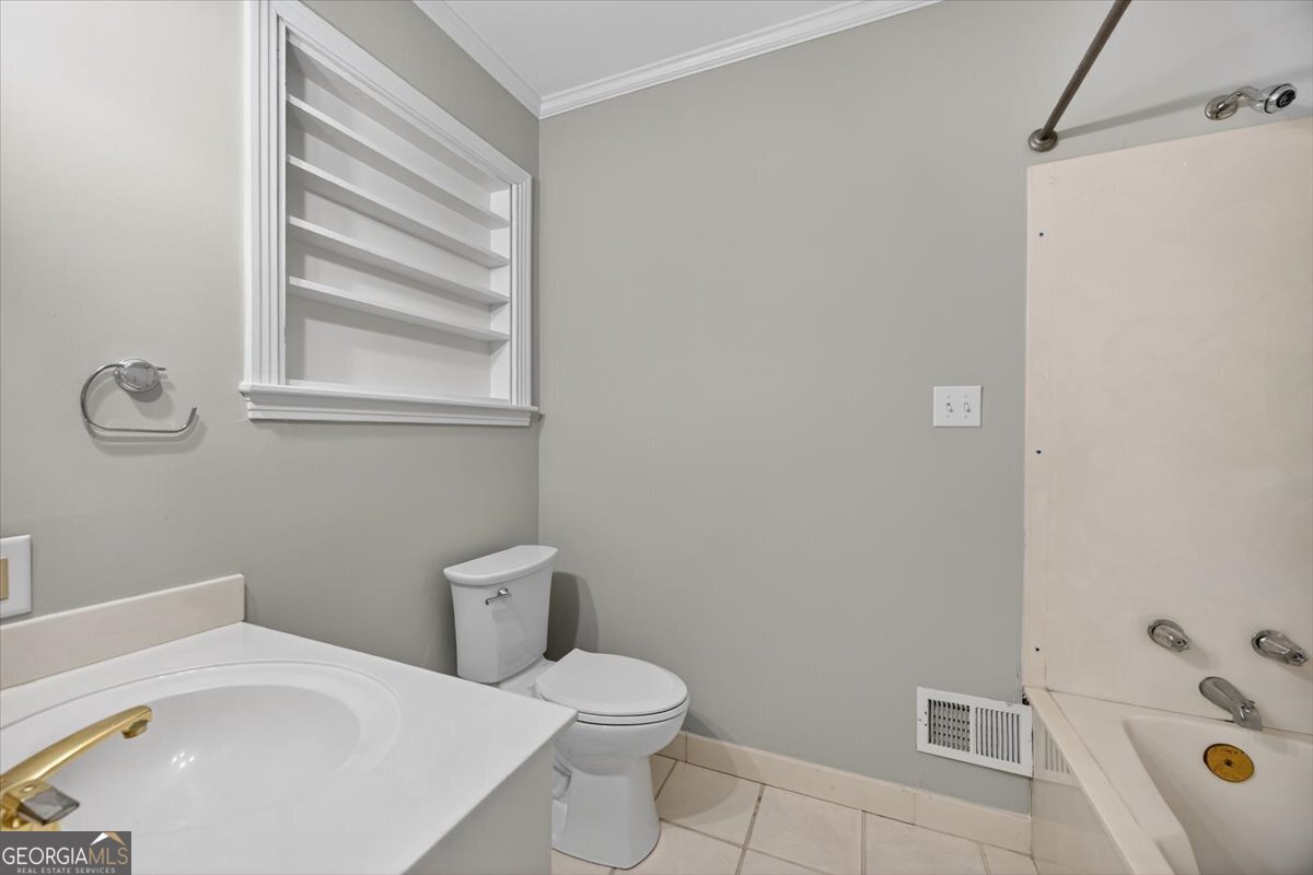 4555 Old Club Road Macon, GA 31210 - Photo 27 of 38 a white toilet sitting next to a bath tub