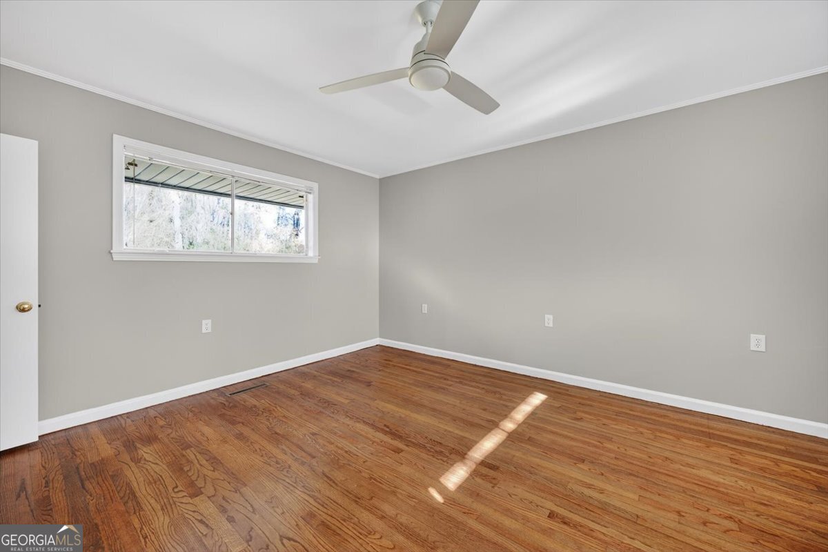 4555 Old Club Road Macon, GA 31210 - Photo 28 of 38 an empty room with wooden floor and windows