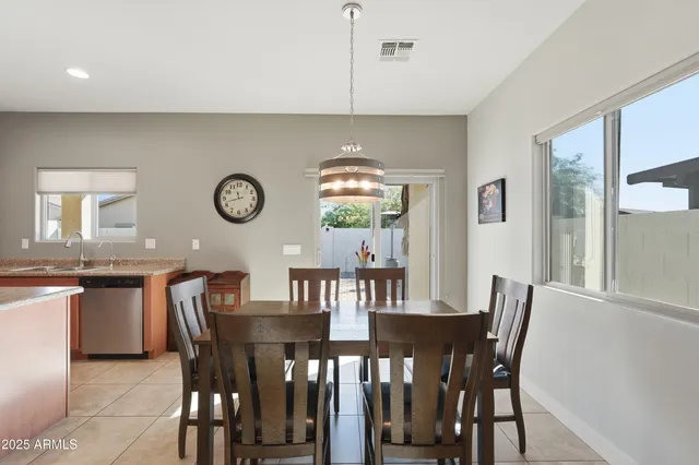 a large kitchen with a table and chairs