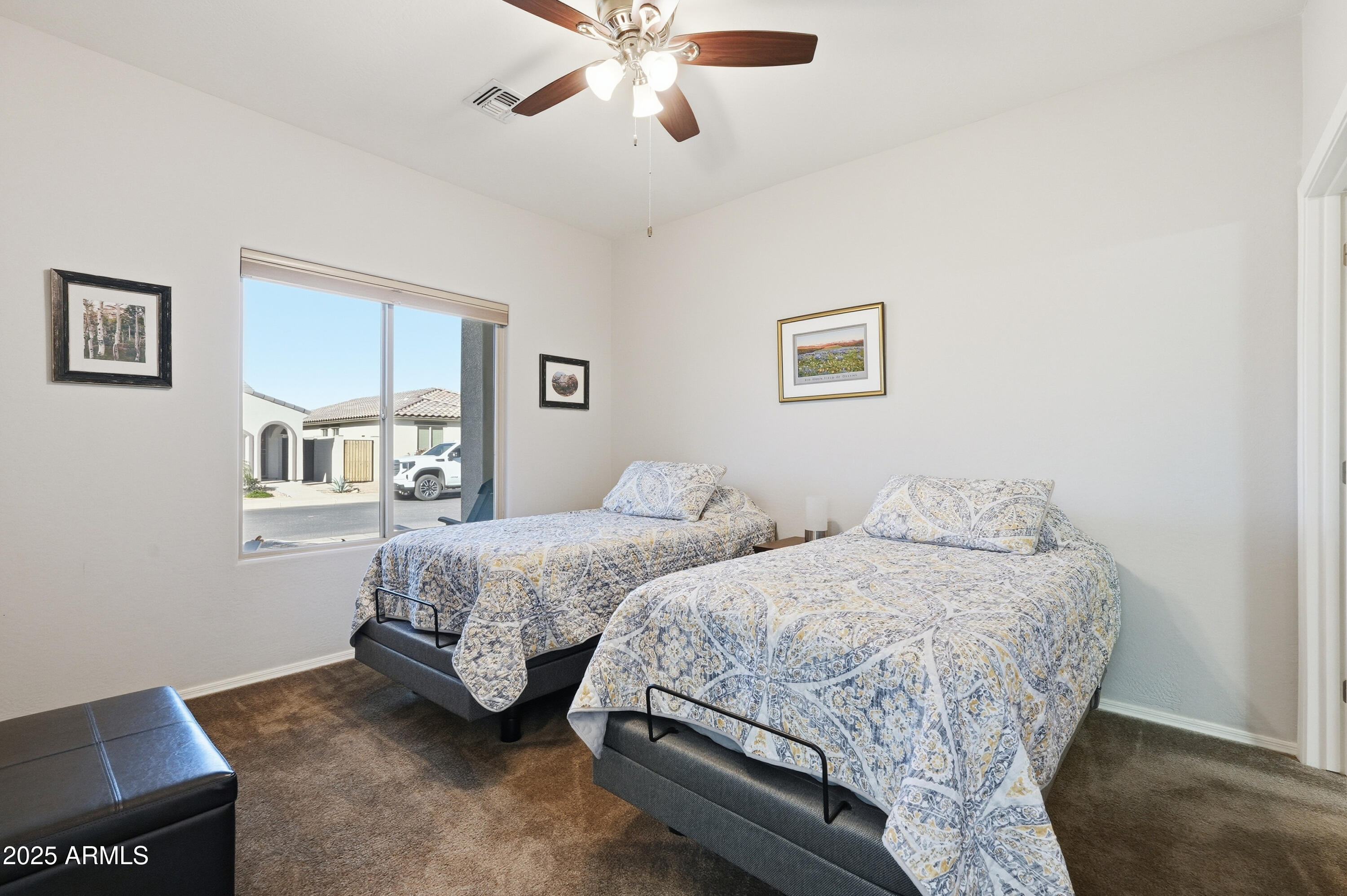 1815 South Hayley Road Apache Junction, AZ 85119 - Photo 15 of 33 a bedroom with two beds and a chandelier