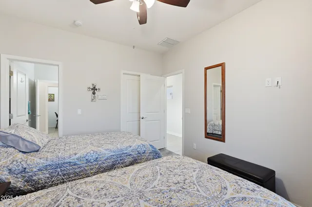 a bedroom with two beds and a chandelier