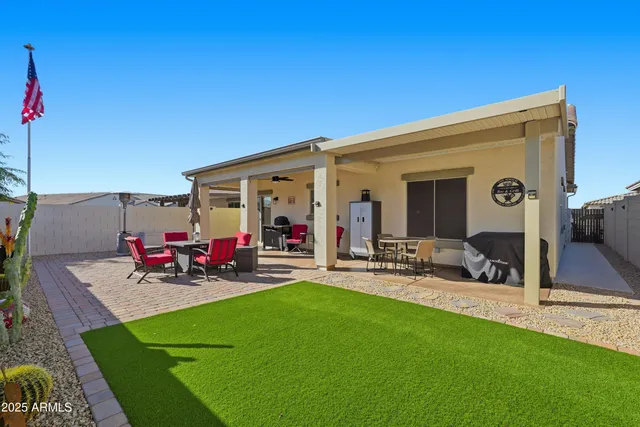 a view of a dinning table and chairs in patio of the house