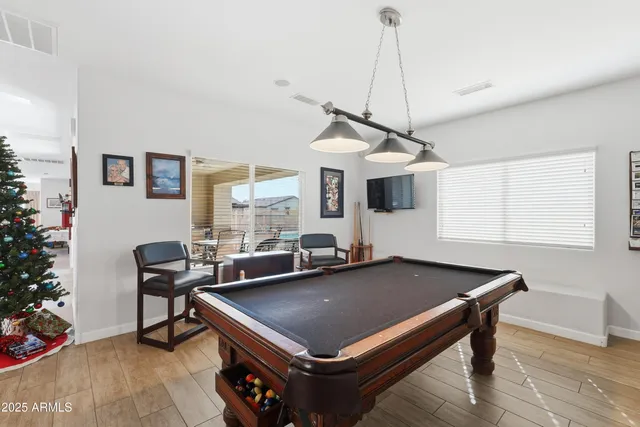 a view of a backyard with furniture and garden