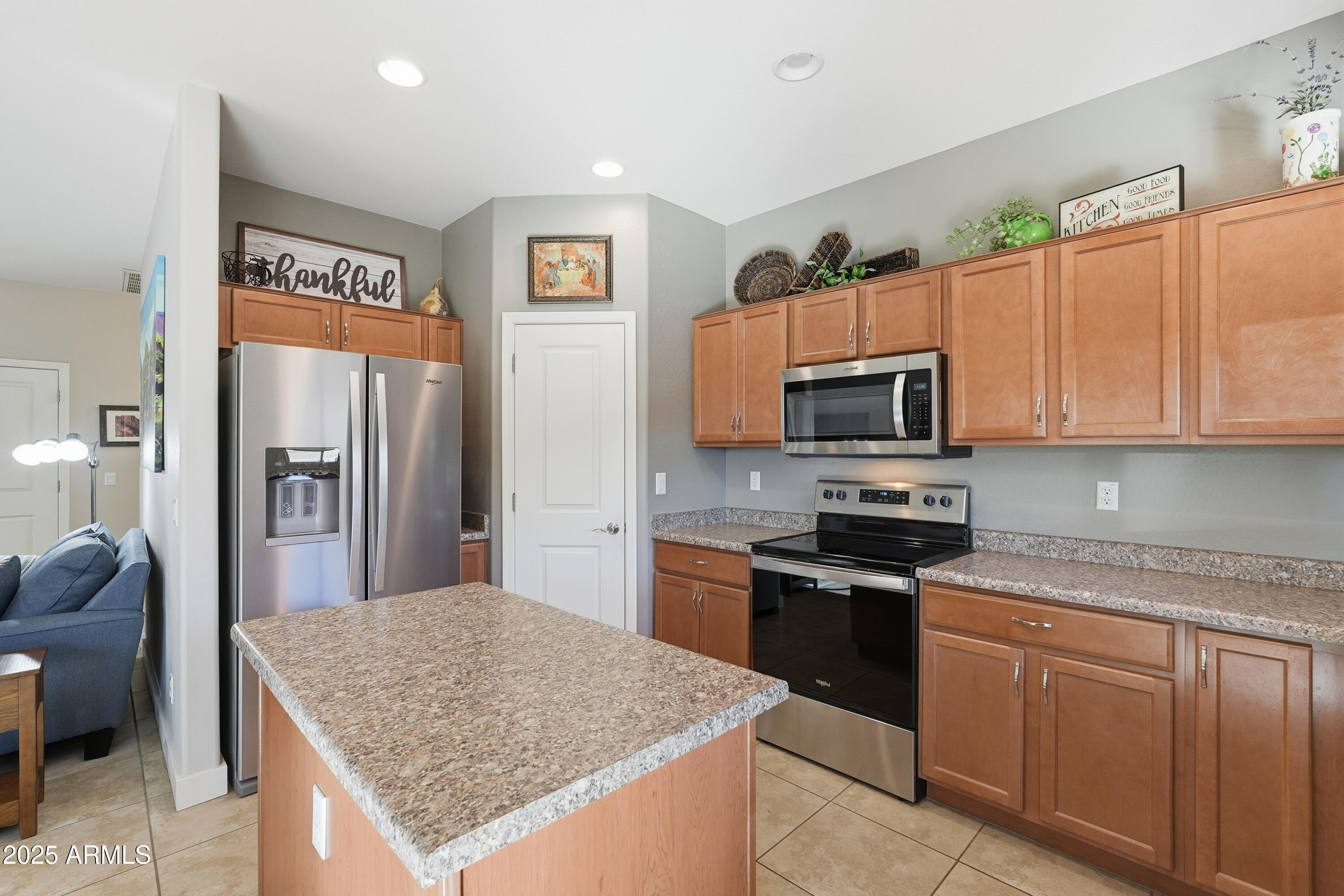 1815 South Hayley Road Apache Junction, AZ 85119 - Photo 8 of 33 a kitchen with stainless steel appliances granite countertop a stove top oven microwave and refrigerator