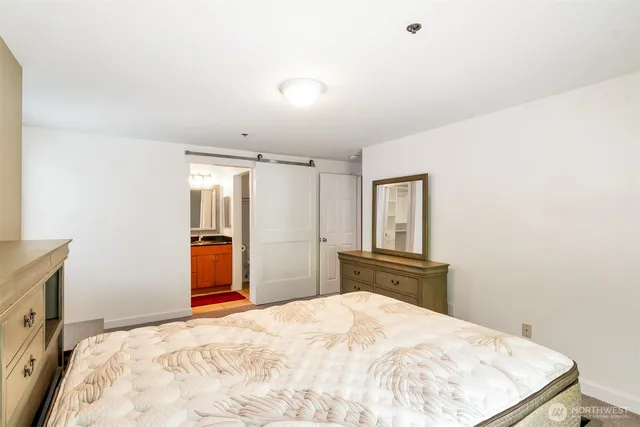 a bedroom with a bed and dresser