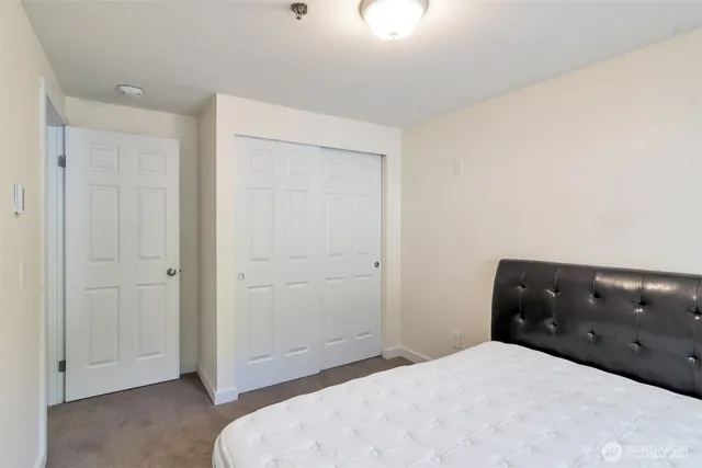 a bedroom with a bed and cabinets