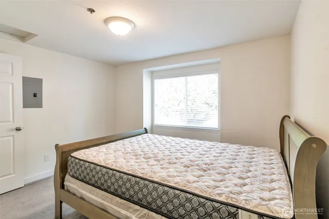 a bedroom with a bed and a window