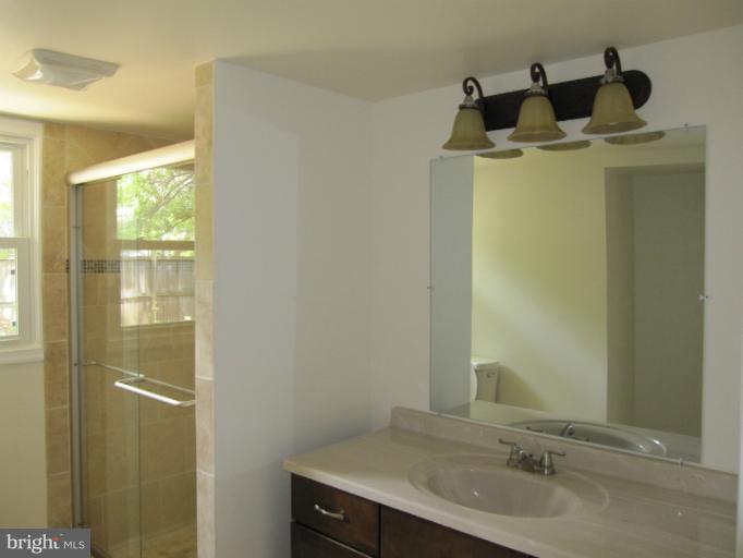 3240 Birchtree Lane Silver Spring, MD 20906 - Photo 2 of 19 a bathroom with a sink and mirror