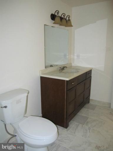 3240 Birchtree Lane Silver Spring, MD 20906 - Photo 13 of 19 a bathroom with a toilet sink and mirror