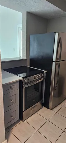 a stove top oven sitting inside of a kitchen