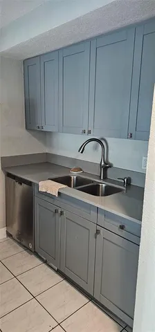 a dirty bathroom with a glass door