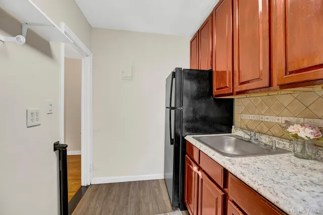 a kitchen with stainless steel appliances granite countertop a refrigerator and a sink