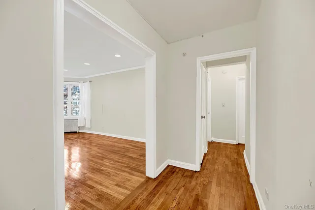 a view of hallway with wooden floor