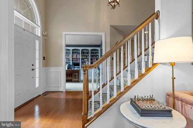 a dining room with furniture a chandelier and wooden floor