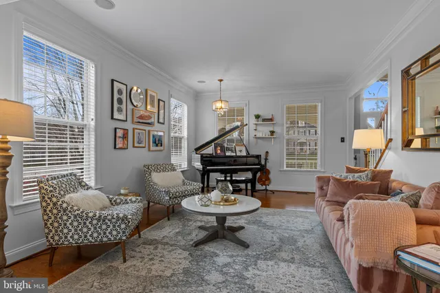 a living room with furniture and a chandelier