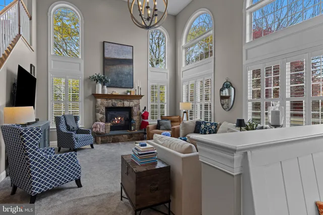a living room with furniture a rug and a large window