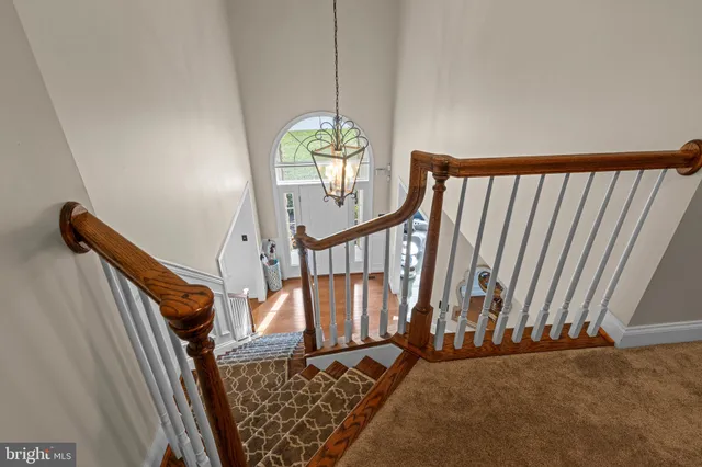 a view of a big house with a big yard and large trees