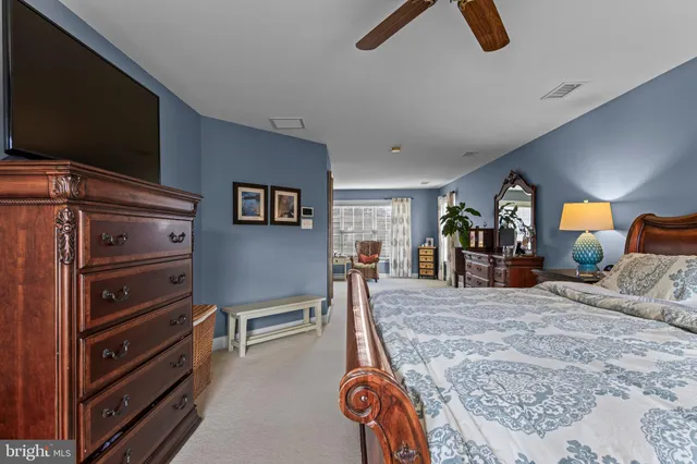 an aerial view of a house with a garden and lake view