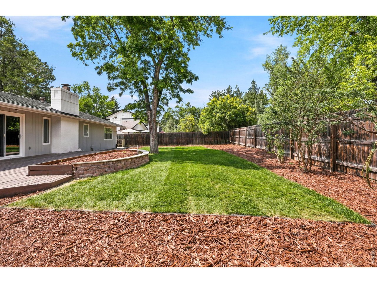 4788 Briar Ridge Trail Boulder, CO 80301 - Photo 40 of 45 Spacious, fully fenced backyard featuring a large deck off the kitchen, new sod, fresh mulch, raised garden bed and a professional-grade sprinkler system.