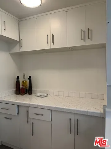 a kitchen with a sink dishwasher and cabinets