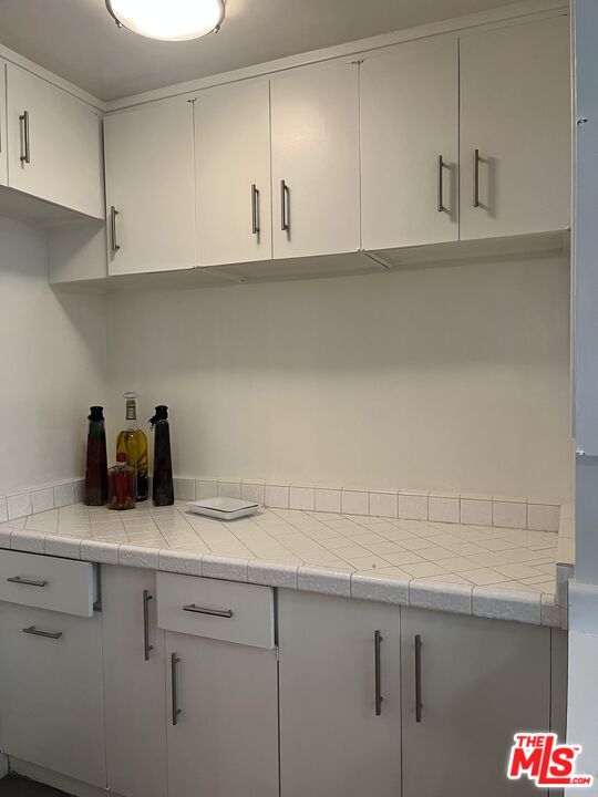 10655 Wilshire Boulevard, Unit 201 Los Angeles, CA 90024 - Photo 13 of 21 a kitchen with a sink dishwasher and cabinets