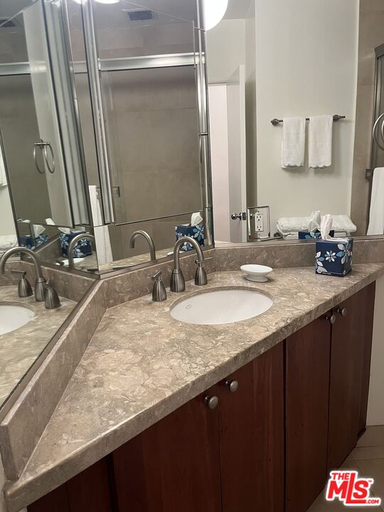 10655 Wilshire Boulevard, Unit 201 Los Angeles, CA 90024 - Photo 15 of 21 a bathroom with a sink and a mirror