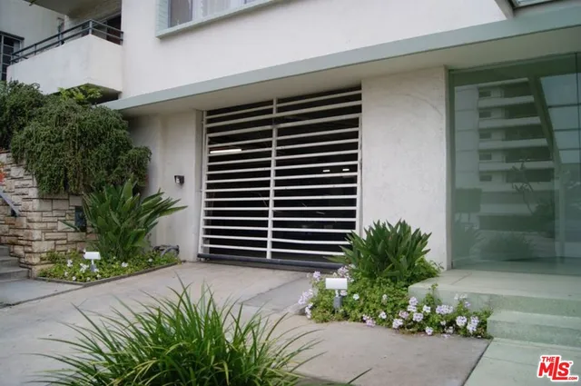 a front view of a house with plants