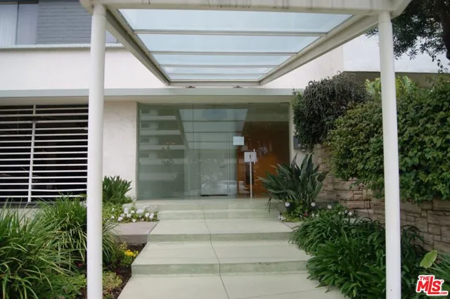 a view of a porch with plants and entryway