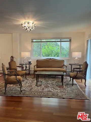 a living room with furniture and a chandelier