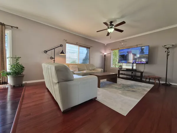 a living room with furniture and a chandelier