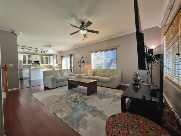 a living room with furniture wooden floor and a rug