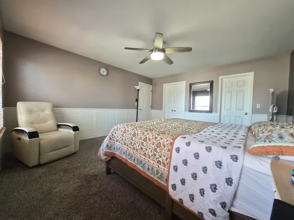 a bedroom with a bed couch and window