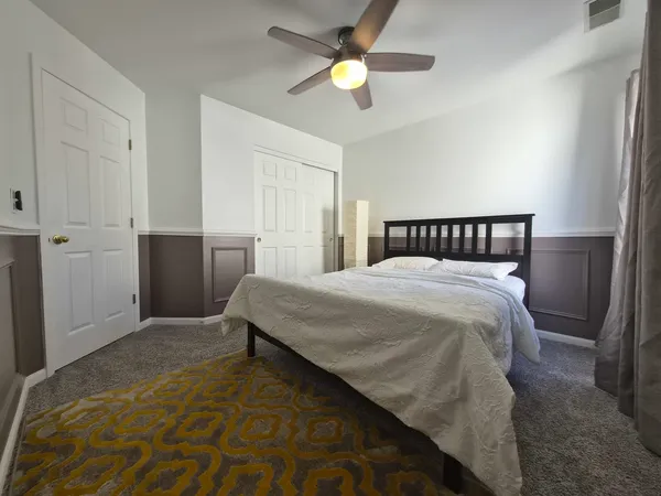 a bedroom with a bed and a chandelier