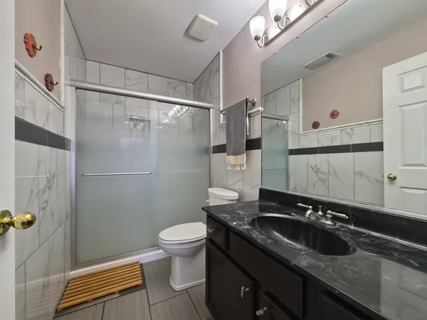 a bathroom with a sink a toilet and a shower