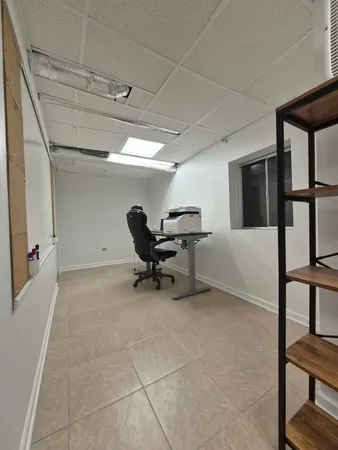 a view of a hallway with wooden floor and furniture