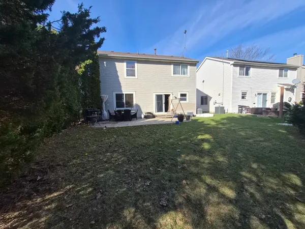 a view of a house with backyard and sitting area