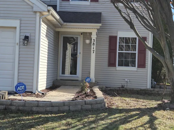 a front view of a house with garage and windows
