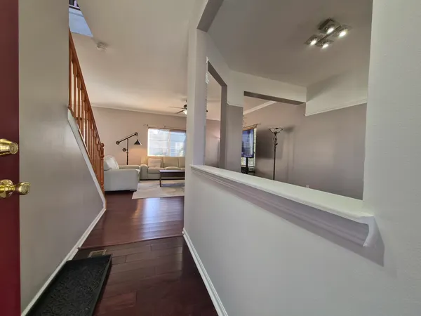 a view of a hallway view with wooden floor and staircase