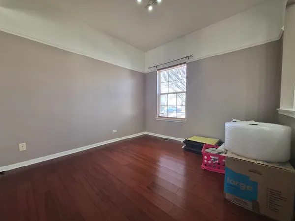 a view of room with hardwood floor and window